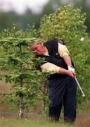 30 June 1999; John Daly plays from behind a tree on the third hole during the Pro Am ahead of the Murphy's Irish Open at Druids Glen Golf Resort in Wicklow. Photo by David Maher/Sportsfile