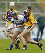 15 April 2006; Darren Stamp, Wexford, in action against Kevin O'Keeffe, Laois. Allianz National Hurling League, Division 1, Relegation Semi-Final, Wexford v Laois, Nowlan Park, Kilkenny. Picture credit: Damien Eagers / SPORTSFILE