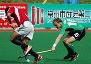 17 April 2006; Ireland's Mark Irwin attempts to retrieve the ball from his Egyptian opponent. Ireland were defeated 3-2 and they must now win their final pool game against Pakistan on Wednesday to reach the play-offs for the final qualifying spot. BDO Men's Hockey World Cup Qualifier, Pool A, Ireland v Egypt, Changzhou, China.  Issued by SPORTSFILE on behalf of the Irish Sports Council