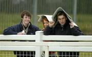 17 April 2006; Racefans try to shelter from the rain during the Powers Whiskey Irish Grand National. Fairyhouse Racecourse, Co. Meath. Picture credit: Pat Murphy / SPORTSFILE