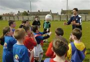 18 April 2006; Former Republic of Ireland star Niall Quinn helps young players to practice their heading during the 4th Annual Docklands Festival of Football. Tolka Rovers FC, Frank Cooke Park, Griffith Avenue, Dublin. Picture credit: Pat Murphy / SPORTSFILE