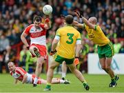 25 May 2014; Mark Lynch, Derry, gets a shot away despite the attempted block of Neil Gallagher, Donegal. Ulster GAA Football Senior Championship Quarter-Final, Derry v Donegal, Celtic Park, Derry. Picture credit: Oliver McVeigh / SPORTSFILE