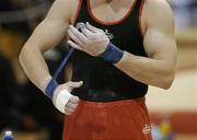 22 April 2006; A gymnast straps up his wrists before competing. National Team Gymnastics Championships, National Basketball Arena, Tallght, Dublin. Picture credit: Brendan Moran / SPORTSFILE