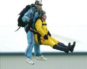 22 April 2006; Noel Grealish, T.D, Galway west, lands with the aid of tandem master John Byrnes in aid of the Alan Kerins African Projects, Irish Parachute Club, Clonbullogue. Picture credit: Damien Eagers / SPORTSFILE