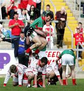 23 April 2006; Mayo players celebrate at the end of the game as Tyrone players fall to their knees. Cadbury's All-Ireland U21 Football Championship Semi-Final, Mayo v Tyrone, Kingspan Breffni Park, Cavan. Picture credit: Oliver McVeigh / SPORTSFILE