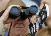 26 April 2006; A racefan keeps a close eye on the Punchestown Guinness Gold Cup. Punchestown Racecourse, Co. Kildare. Picture credit: Pat Murphy / SPORTSFILE