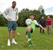 27 May 2014; Alex Elliott, age 9, from Culmullen National School, Co. Meath, shows his skills off to Republic of Ireland international David Meyler  during a visit to their school. Culmullen National School, Co. Meath. Picture credit: David Maher / SPORTSFILE