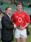 29 April 2006; Paul Nicholson, Cadburys Area Manager, presents the man of the match award to Fintan Gould, Cork. Fintain is now shortlisted for the Hero of the Future Award. Cadbury's U21 Football Semi-final Replay. Laois v Cork, Gaelic Grounds, Limerick. Picture credit: Kieran Clancy / SPORTSFILE