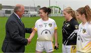 3 May 2014; Pat Quill, President of the Ladies Gaelic Football Association, is greeted by Antrim captain Ruth Finlass before the game. TESCO Ladies National Football League Division 4 Final, Antrim v Roscommon, O'Connor Park, Tullamore, Co. Offaly. Picture credit: Ray McManus / SPORTSFILE