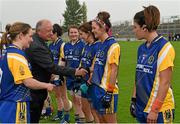 3 May 2014; Pat Quill, President of the Ladies Gaelic Football Association, shakes hands with Amanda McLoone as greets the Roscommon team before the game. TESCO Ladies National Football League Division 4 Final, Antrim v Roscommon, O'Connor Park, Tullamore, Co. Offaly. Picture credit: Ray McManus / SPORTSFILE