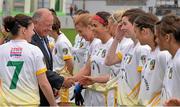 3 May 2014; Pat Quill, President of the Ladies Gaelic Football Association, shakes hands with Shannon Graham as greets the Antrim team before the game. TESCO Ladies National Football League Division 4 Final, Antrim v Roscommon, O'Connor Park, Tullamore, Co. Offaly. Picture credit: Ray McManus / SPORTSFILE
