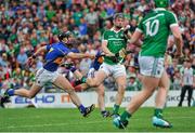 1 June 2014; Full forward Kevin Downes, under pressure from Tipperary's Conor O'Mahony, passes the sliothar to team mate Shane Dowling who ultimately scored the second goal for Limerick. Munster GAA Hurling Senior Championship, Semi-Final, Tipperary v Limerick, Semple Stadium, Thurles, Co. Tipperary. Picture credit: Ashleigh Fox / SPORTSFILE