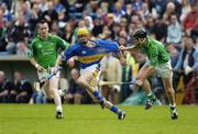 14 May 2006; Shane McGrath, Tipperary, is tackled by Donal O'Grady, right, and Donie Ryan, Limerick. Guinness Munster Senior Hurling Championship Quarter Final, Tipperary v Limerick, Semple Stadium, Thurles, Co. Tipperary. Picture credit; Ray McManus / SPORTSFILE