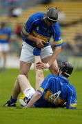 14 May 2006; The Tipperary full-back Philip Maher assists his corner-back Paul Curran to overcome cramp in the final minutes. Guinness Munster Senior Hurling Championship Quarter Final, Tipperary v Limerick, Semple Stadium, Thurles, Co. Tipperary. Picture credit; Ray McManus / SPORTSFILE