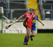 14 May 2006; Angela Walsh, Cork, kicks the sliothar under pressure from Trish O'Halloran, Tipperary. Camogie National League Division 1A Final, Cork v Tipperary, Semple Stadium, Thurles, Co. Tipperary. Picture credit; Ray McManus / SPORTSFILE