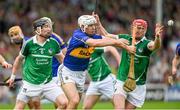 1 June 2014; Niall O'Meara, Tipperary, in action against Wayne McNamara, left, and Seamus Hickey, Limerick. Munster GAA Hurling Senior Championship, Semi-Final, Tipperary v Limerick, Semple Stadium, Thurles, Co. Tipperary. Picture credit: Diarmuid Greene / SPORTSFILE