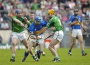 14 May 2006; Ken Dunne, Tipperary, is tackled by Brian Geary, left, and Paul O'Grady, Limerick. Guinness Munster Senior Hurling Championship Quarter Final, Tipperary v Limerick, Semple Stadium, Thurles, Co. Tipperary. Picture credit; Ray McManus / SPORTSFILE