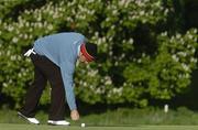 18 May 2006; Paul McGinley, Ireland, marks his ball on the 10th green during the first round. McGinley withdrew from the competition with a knee injury while play was suspended. Nissan Irish Open Golf Championship, Carton House Golf Club, Maynooth, Co. Kildare. Picture credit; Brendan Moran / SPORTSFILE
