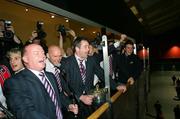 20 May 2006; Munster coach Declan Kidney, John Hayes and captain Anthony Foley singing 'the Fields of Athenry' for fans on their arrival at Shannon Airport with the Heineken Cup after the Heineken Cup Final in Cardiff. Picture credit; Kieran Clancy / SPORTSFILE