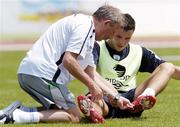 21 May 2006; Republic of Ireland epuipment officer Joe Walsh replaces a stud on the boot of John O'Shea during squad training. Municipal Stadium, Lagos, Portugal. Picture credit; David Maher / SPORTSFILE