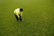 21 May 2006; Groundsman James Flaherty uses a fork to try and relace some of the surface water on the pitch. The minor game was played to half-time but it and the senior game were postponed after an inspection. Bank of Ireland Connacht Senior Football Championship, Quarter-final, Galway v Sligo, Pearse Stadium, Galway. Picture credit; Ray McManus / SPORTSFILE