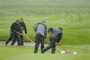 21 May 2006; Green keepers at work on the 6th fairway before it was announced that play would be suspended until tomorrow. Nissan Irish Open Golf Championship. Carton House Golf Club, Maynooth, Co. Kildare. Picture credit; Brian Lawless / SPORTSFILE