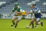 21 May 2006; Joe Bergin, Offaly, in action against Pakie Cuddy and John A Delaney, Laois. Guinness Leinster Senior Hurling Championship, Quarter-final, Laois v Offaly, O'Moore Park, Portlaoise, Co. Laois. Picture credit; Brendan Moran / SPORTSFILE