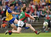 8 June 2014; Ciaran Cafferkey, Roscommon, scores the only goal of the game against Mayo despite the presents of Donal Vaughan. Connacht GAA Football Senior Championship, Semi-Final, Roscommon v Mayo, Dr. Hyde Park, Roscommon. Picture credit: Matt Browne / SPORTSFILE