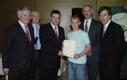 22 May 2006; Brian Lenihan T.D., Minister of State at the Department of Health and Children, 3rd from left, assisted by, from left, Vincent Butler, FAI, Harry McCue, FAI, Martin Quilty, FETAC, and John Delaney, CEO of the Football Association of Ireland, presents a certificate to Mark Duggan, one of to 24 graduates of the 2005 FÁS/FAI Training Programme. John Paul Park, Cabra, Dublin. Picture credit: Damien Eagers / SPORTSFILE
