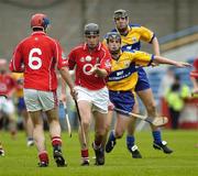 28 May 2006; Darren Ninneen, Cork, under pressure from Clare's Michael Howes passes to his team-mate Darragh McSweeney. Munster Intermediate Hurling Championship, Semi-final, Clare v Cork, Semple Stadium, Thurles, Co. Tipperary. Picture credit; Ray McManus / SPORTSFILE