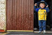 8 June 2014; Roscommon supporter Sean McCann, aged 3, from Lisacull shelters from the heavy rain before the game. Connacht GAA Football Senior Championship, Semi-Final, Roscommon v Mayo, Dr. Hyde Park, Roscommon. Picture credit: Barry Cregg / SPORTSFILE