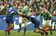 14 February 2004; Paul O'Connell of Ireland is tackled by William Servert, left, and Pieter de Villiers of France during the RBS Six Nations Rugby Championship match between France and Ireland at Stade de France in Paris, France. Photo by Brendan Moran/Sportsfile