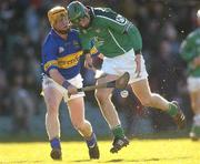 29 February 2004; Donie Ryan of Limerick in action against Eamon Corcoran of Tipperary during the Allianz Hurling League Division 1B match between Limerick and Tipperary at the Gaelic Grounds in Limerick. Photo by Damien Eagers/Sportsfile