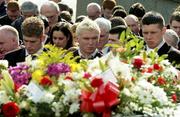 5 March 2005; Tyrone players, from left, Kevin Hughes, Owen Mulligan and Sean Cavanagh look on as the coffin of their team-mate passes by at the funeral of Tyrone footballer Cormac McAnallen at St Patrick's Church in Eglish, Tyrone. Photo by Ray McManus/Sportsfile