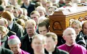 5 March 2005; Father of Cormac, Brendan McAnallen, walks alongside the coffin at the funeral of Tyrone footballer Cormac McAnallen at St Patrick's Church in Eglish, Tyrone. Photo by Ray McManus/Sportsfile