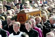 5 March 2005; Eglish and Tyrone players carry the coffin at the funeral of Tyrone footballer Cormac McAnallen at St Patrick's Church in Eglish, Tyrone. Photo by Ray McManus/Sportsfile