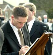 5 March 2005; Armagh captain Kieran McGeeney signs a book of condolence at the funeral of Tyrone footballer Cormac McAnallen at St Patrick's Church in Eglish, Tyrone. Photo by Ray McManus/Sportsfile