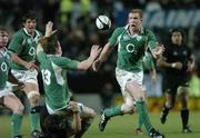 10 June 2006; Brian O'Driscoll, Ireland, is tackled by Richie McCaw, New Zealand as he gets the ball away to Paul O'Connell during the closing stages of the game. Summer Tour 2006, New Zealand v Ireland,  Waikato Stadium, Hamilton, New Zealand. Picture credit: Matt Browne / SPORTSFILE
