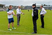 14 June 2014; Kildare manager Brian Lawlor, left, discusses the new penalty interpretations before the game with referee John Keenan, second from left, and linesmen Christy Brown and Justin Heffernan, right. GAA All-Ireland Hurling Senior Championship Promotion Play Off, Westmeath v Kildare, Cusack Park, Mullingar, Co. Westmeath. Picture credit: Piaras Ó Mídheach / SPORTSFILE