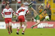 18 June 2006; Barry Dunnion, Donegal, is sent flying by Fergal Doherty (12), Derry. Bank of Ireland Ulster Senior Football Championship Semi-Final, Donegal v Derry, St. Tighearnach's Park, Clones, Co. Monaghan. Picture credit: Brendan Moran / SPORTSFILE