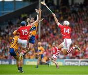 15 June 2014; The Cork captain Patrick Cronin, supported by Patrick Horgan, wins possession ahead of Clare defenders Brendan Bugler and Cian Dillon. Munster GAA Hurling Senior Championship, Semi-Final, Clare v Cork, Semple Stadium, Thurles, Co. Tipperary. Picture credit: Ray McManus / SPORTSFILE