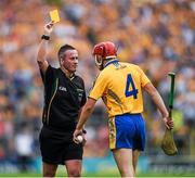 15 June 2014; Referee James McGrath issues a yellow card to Clare's Jack Browne late in the first half. Munster GAA Hurling Senior Championship, Semi-Final, Clare v Cork, Semple Stadium, Thurles, Co. Tipperary. Picture credit: Ray McManus / SPORTSFILE