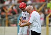 15 June 2014; Cork kitman Pat Keane helps goalkeeper Anthony Nash fix his hurley before the game. Munster GAA Hurling Senior Championship, Semi-Final, Clare v Cork, Semple Stadium, Thurles, Co. Tipperary. Picture credit: Dáire Brennan / SPORTSFILE