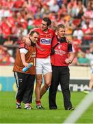 15 June 2014; Mark Ellis, Cork, is assisted off the pitch near the end of the game. Munster GAA Hurling Senior Championship, Semi-Final, Clare v Cork, Semple Stadium, Thurles, Co. Tipperary. Picture credit: Ray McManus / SPORTSFILE