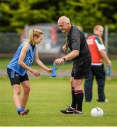15 May 2014; Referee Eugene O'Hara offers a drink to Nicole Owens, Dublin, before she scored her side's fourth goal from a penalty. Aisling McGing Ladies U21 Football Final, Dublin v Meath, Clane, Co. Kildare. Picture credit: Piaras Ó Mídheach / SPORTSFILE
