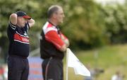 17 June 2006; Louth manager Eamon McEneaney, left, reacts to the play while Tyrone manager Mickey Harte doesn't. Bank of Ireland All-Ireland Senior Football Championship Qualifier, Round 1, Louth v Tyrone, Pairc Tailteann, Navan, Co. Meath. Picture credit: Brendan Moran / SPORTSFILE
