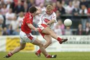 24 June 2006; Owen Mulligan, Tyrone, fires in a shot on goal despite the attentions of Peter McGinnity, Louth. Bank of Ireland All-Ireland Senior Football Championship Qualifier, Round 1 Replay, Tyrone v Louth, Healy Park, Omagh, Co. Tyrone. Picture credit: Brendan Moran / SPORTSFILE