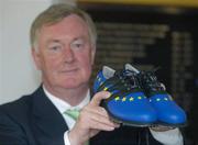 29 June 2006; John O'Donoghue, T.D., Minister for Arts, Sport and Tourism, who today opened the prestigious World Golf Hall of Fame exhibit at Waterford Crystal,, the official sponsor of the 2006 Ryder Cup, holds the specially made European team colour golf shoes, that Berhard Langer wore when he lead Europe to victory against the U.S.A. in 2004. Waterford Crystal Visitor Centre, Waterford Crystal, Waterford. Picture credit: Brian Lawless / SPORTSFILE