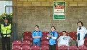 30 June 2006; Four UCD supporters cheer on their side watched by a local Garda. eircom League, Premier Division, Cork City v UCD, Turners Cross, Cork. Picture credit: Brendan Moran / SPORTSFILE