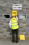 22 June 2014; Local official Michael Moloney reaches for a nail in his pocket as he nails on the admission price in advance of the game. Munster GAA Football Senior Championship, Semi-Final, Clare v Kerry, Cusack Park, Ennis, Co. Clare. Picture credit: Ray McManus / SPORTSFILE